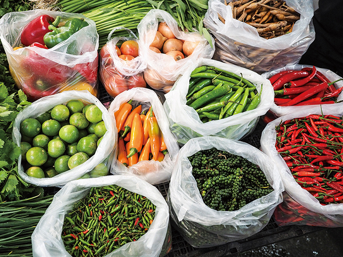 The diversity of fruits and vegetables for sale at the market in Kanchanaburi reflect Thailand’s changing society